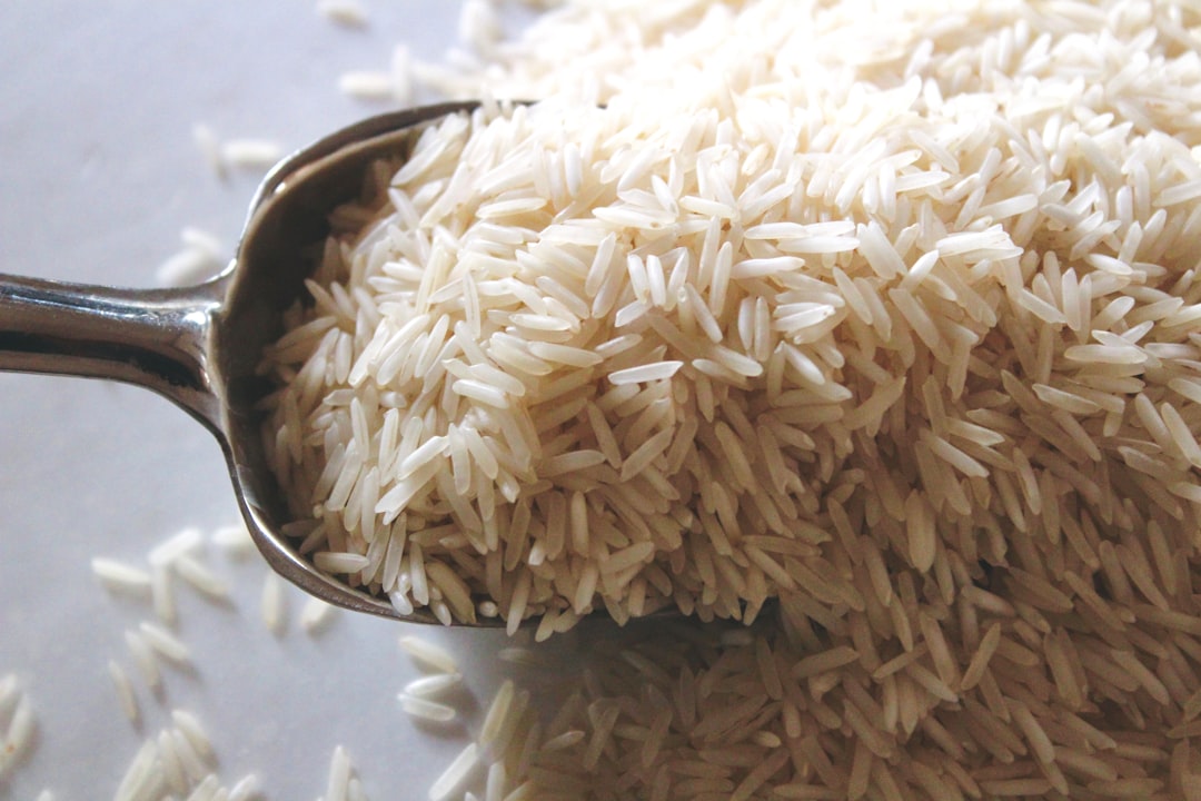 a-spoon-filled-with-rice-on-top-of-a-table-q5ofm2gybwm
